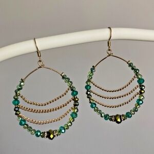 Green / gold tone hoop earrings with chain design inside the hoop